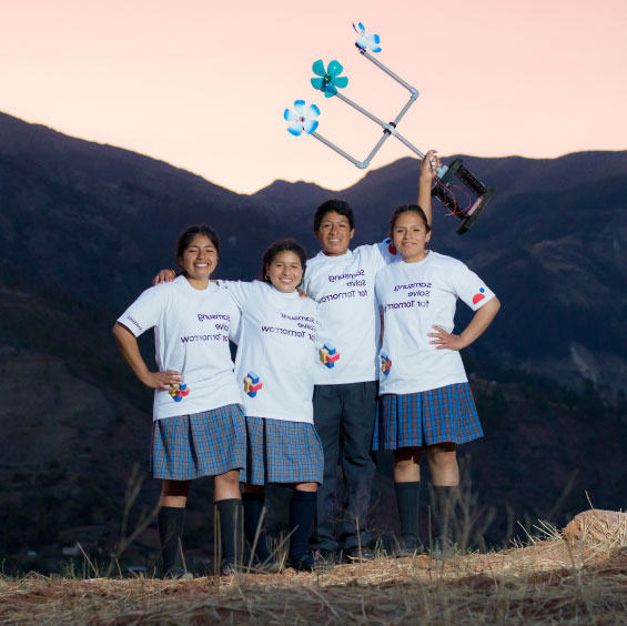 Four students wearing Samsung Solve for Tomorrow T-shirts posing for a photo